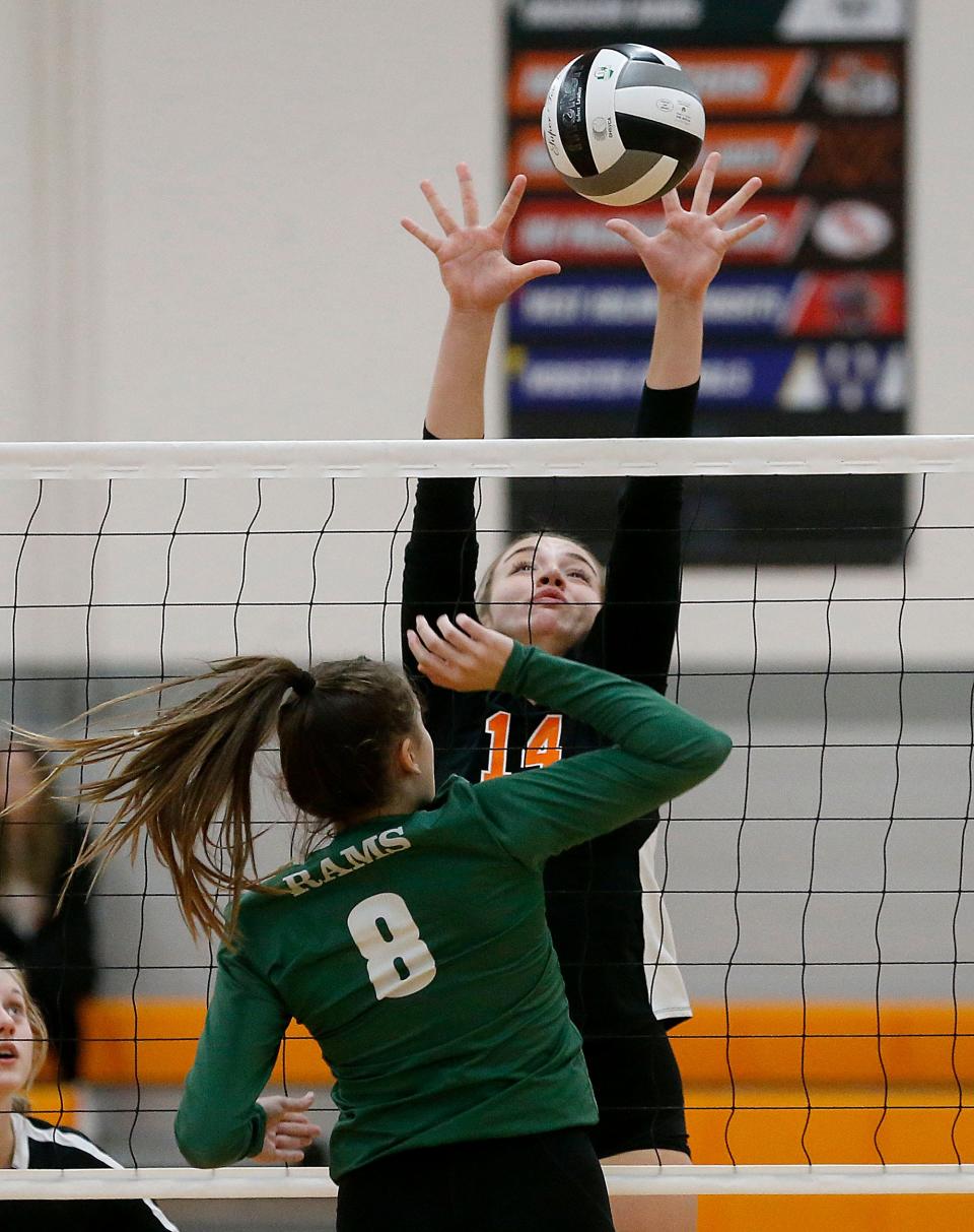 Ashland High School's Elysia Zehner (14) blocks a shot by Madison High School's Addison Farris (8) during high school volleyball action at Ashland High School Monday, Oct. 17, 2022. TOM E. PUSKAR/ASHLAND TIMES-GAZETTE