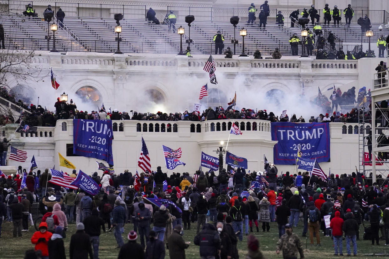 FILE - Insurrectionists loyal to President Donald Trump, storm the Capitol, Wednesday, Jan. 6, 2021, in Washington. Three active-duty Marines have been charged in the riot at the U.S. Capitol. Court records show that Micah Coomer, Joshua Abate and Dodge Dale Hellonen were arrested this week on misdemeanor charges after fellow Marines helped investigators identify them in footage among the pro-Trump mob on Jan. 6, 2021. (AP Photo/John Minchillo, File)