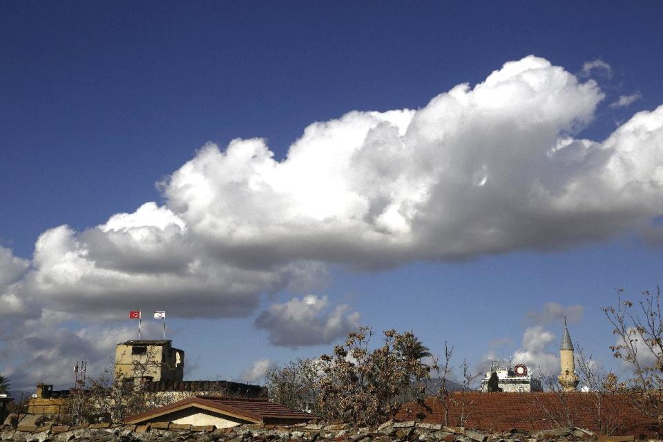 This photo taken from the Greek Cypriot controlled area in the south, shows a Turkish military guard post, left, and a minaret of a mosque in the right, both at the Turkish Cypriot breakaway northern part of the divided capital Nicosia in the eastern Mediterranean island of Cyprus, Wednesday, Jan. 11, 2017. The rivals leaders of Cyprus have begun a third day of talks aimed at reunifying the island split along ethnic Greek and Turkish lines. The talks will take on an international dimension on Thursday with the arrival of leaders from Britain, Greece and Turkey. (AP Photo/Petros Karadjias)