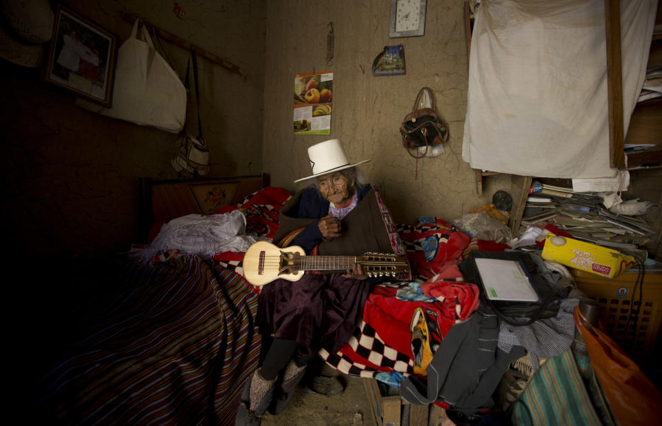 In this Aug. 23, 2018 photo, 117-year-old Julia Flores Colque holds a "charango," a small Andean stringed instrument, at her home in Sacaba, Bolivia. Flores Colque still sings in her indigenous Quechua tongue and strums the five strings of her tiny Andean guitar. (AP Photo/Juan Karita)