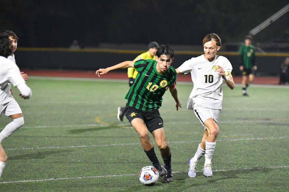 Moorpark midfielder Javier Castro protects the ball from Oak Park's Zack Harris in the Eagles' 3-0 win at Moorpark on Tuesday.