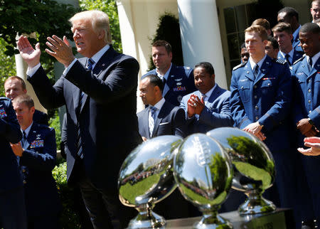 U.S. President Donald Trump applauds the U.S. Air Force Academy football team as he presents them with the Commander-in-Chief trophy in the Rose Garden of the White House in Washington, U.S., May 2, 2017. REUTERS/Joshua Roberts