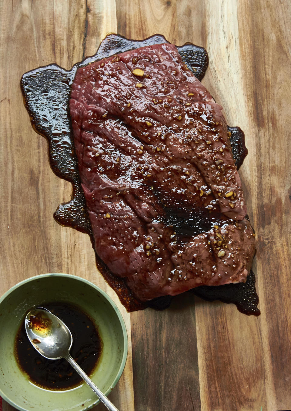 This 2017 photo shows a London Broil marinating before being grilled in New York. Marinating is a terrific basic kitchen technique. Essentially, you can take any kind of meat, fish or seafood, submerge it in a marinade, and you've turned a plain something into a great dinner. (Mia/Katie Workman via AP)