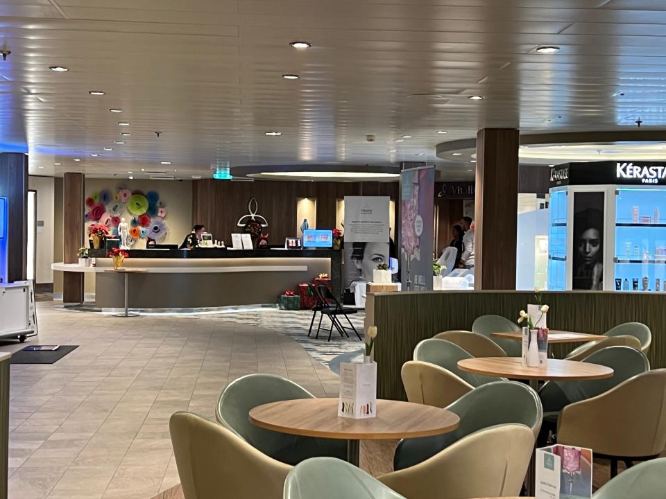 cruise spa with tables in foreground and desk in the background