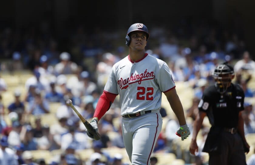 Washington Nationals right fielder Juan Soto (22) walks back to the dugout after striking out against the Dodgers