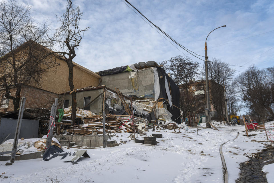 Buildings impacted by Russian missile shelling are seen in Kyiv, Ukraine, Wednesday, Jan. 11, 2023. (AP Photo/Andrew Kravchenko)