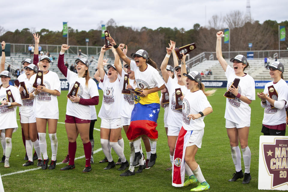 FILE - Florida State celebrates their victory over North Carolina in the NCAA women's soccer championship game in Cary, N.C., Sunday, Dec. 2, 2018. The number of women competing at the highest level of college athletics continues to rise along with an increasing funding gap between men’s and women’s sports programs, according to an NCAA report examining the 50th anniversary of Title IX. (AP Photo/Ben McKeown, File)