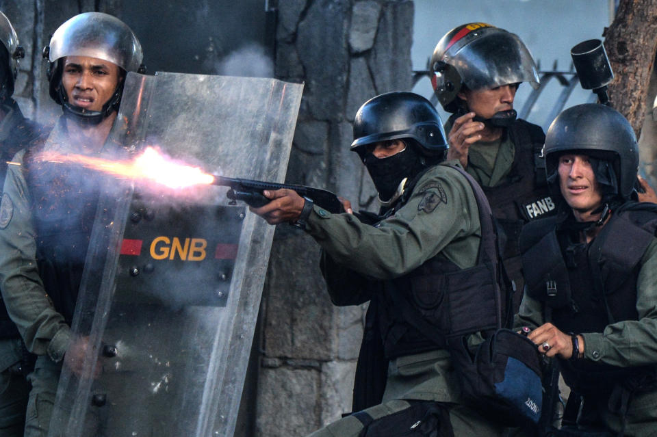 A National Guardsman fires a weapon at opposition demonstrators on July 26.