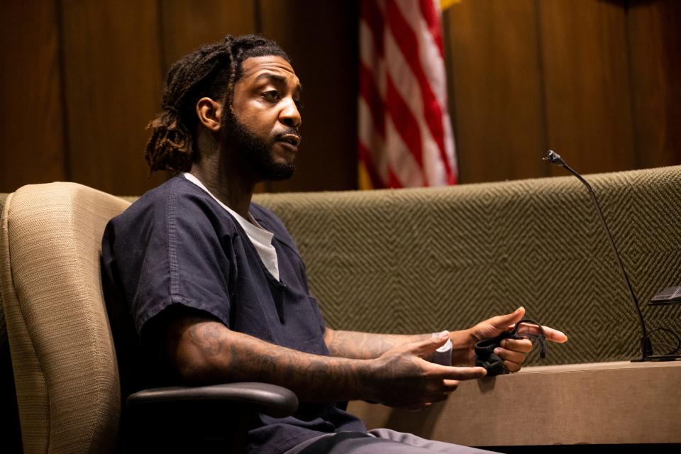 Jermarcus Johnson, who is accused of aiding in the hide out and escape of Justin Johnson and Cornelius Smith after they shot rapper Young Dolph, answers a question from Assistant District Attorney Paul Hagerman on the stand at the Shelby County Criminal Court in Memphis, Tenn., on Friday, June 9, 2023. 