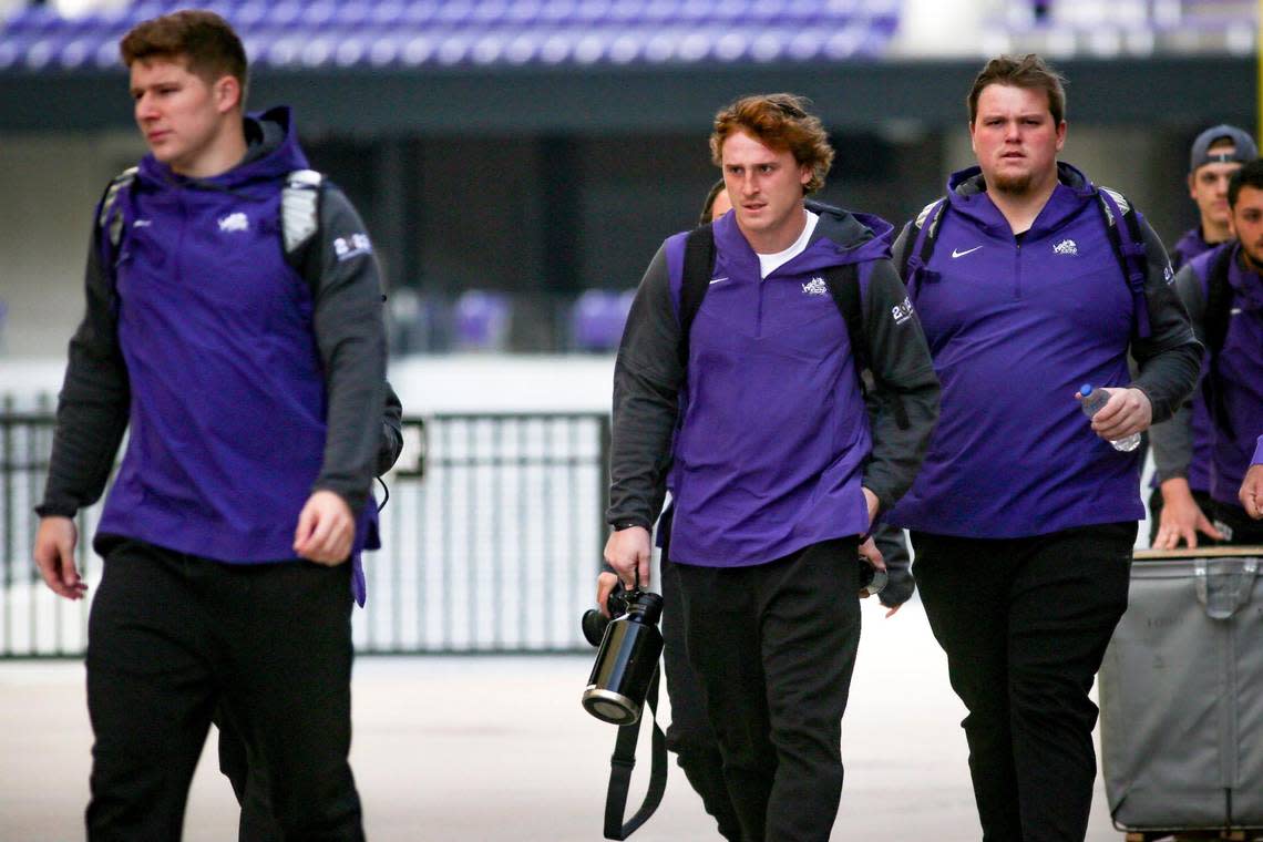 TCU quarterback Max Duggan heads towards a bus with his team to leave for the College Football Championships, outside of the Amon G. Carter Stadium in Fort Worth on Friday, Jan. 6, 2023. As the buses left, fans lined nearby streets to cheer them on.