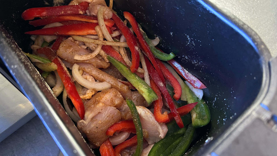 All fajita ingredients in the air fryer basket