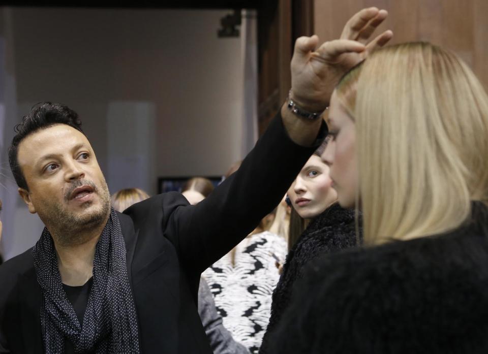 Lebanese fashion designer Zuhair Murad adjusts the hair of a model, backstage at his Haute Couture Spring-Summer 2014 fashion collection, presented in Paris, Tuesday, Jan. 23, 2014. (AP Photo/Jacques Brinon)