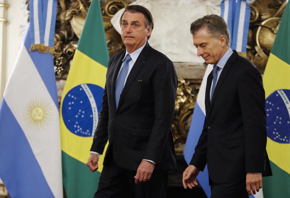 Brazil's President Jair Bolsonaro left, and Argentina's President Mauricio Macri arrive at the government house in Buenos Aires, Argentina, Thursday, June 6, 2019. (AP Photo/Natacha Pisarenko)