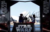 Caleb (L-R), Kayley and Annie Bratayley from the United States participate in a live internet unboxing event to reveal new light saber toys from the film "Star Wars - The Force Awakens" in Sydney, September 3, 2015. REUTERS/Jason Reed