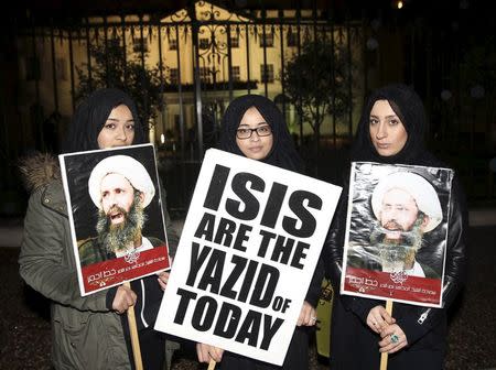 Protesters hold placards as they demonstrate against the execution of prominent Shi'ite cleric Sheikh Nimr al-Nimr outside the Saudi Arabian Embassy in London, Britain January 2, 2016. REUTERS/Neil Hall