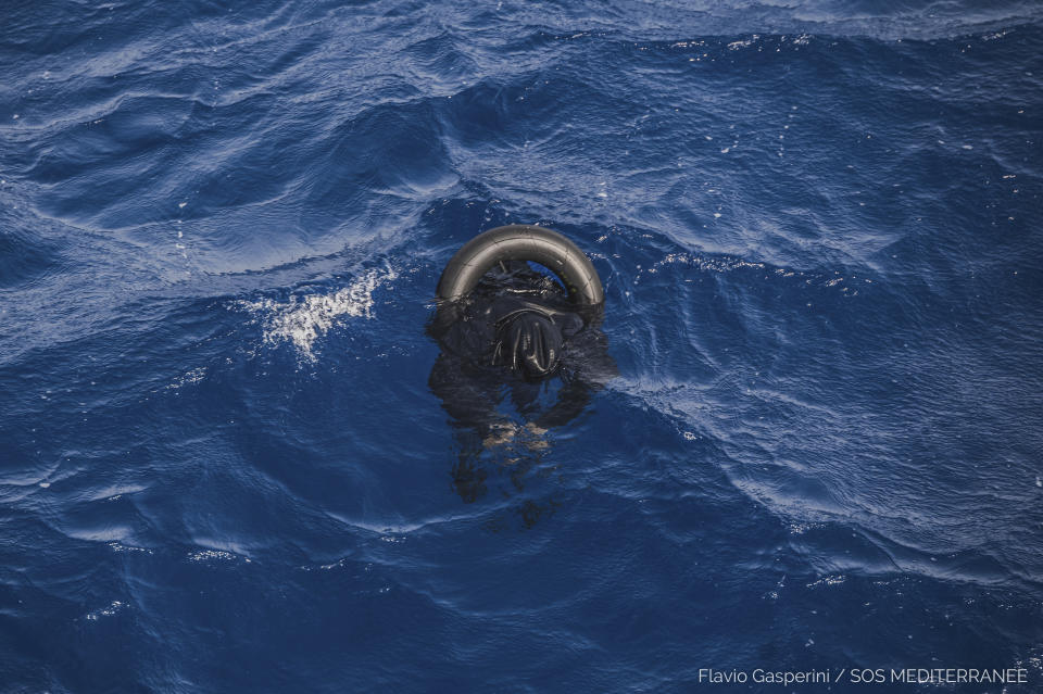 The body of one of the victims of the shipwreck of a dinghy which was supposedly carrying over 100 migrants, is seen floating in the Mediterranean Sea northeast of the Libyan capital, Tripoli, Thursday, April 22, 2021. SOS Mediterranee, which operates the rescue vessel Ocean Viking, said late Thursday that the wreck of a rubber boat, which was initially carrying around 130 people, was spotted in the Mediterranean Sea. The aid vessel did not find any survivors, but could see at least ten bodies near the wreck, the group added in a statement. (Flavio Gasperini/SOS Mediterranee via AP)