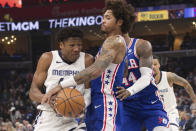 Memphis Grizzlies forward GG Jackson II (45) tries to hold on to the ball while defended by Philadelphia 76ers forward Kelly Oubre Jr., center, and forward Paul Reed (44) during the first half of an NBA basketball game Saturday, April 6, 2024, in Memphis, Tenn. (AP Photo/Nikki Boertman)