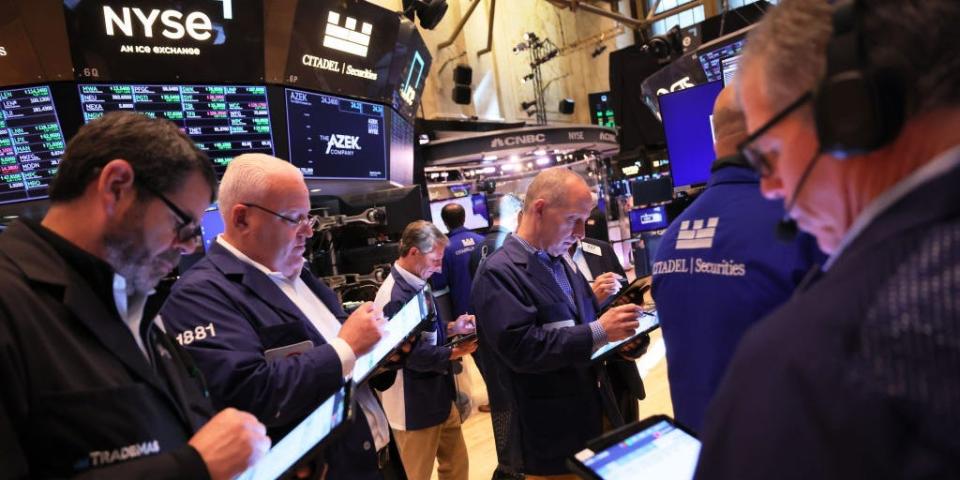 Traders look at computer screens as they work on the floor of the New York Stock Exchange.