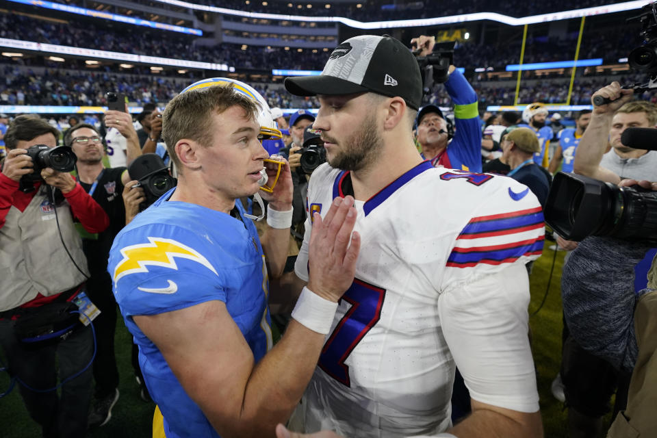 Los Angeles Chargers quarterback Easton Stick, left, talks to Buffalo Bills quarterback Josh Allen after an NFL football game Saturday, Dec. 23, 2023, in Inglewood, Calif. (AP Photo/Ashley Landis)