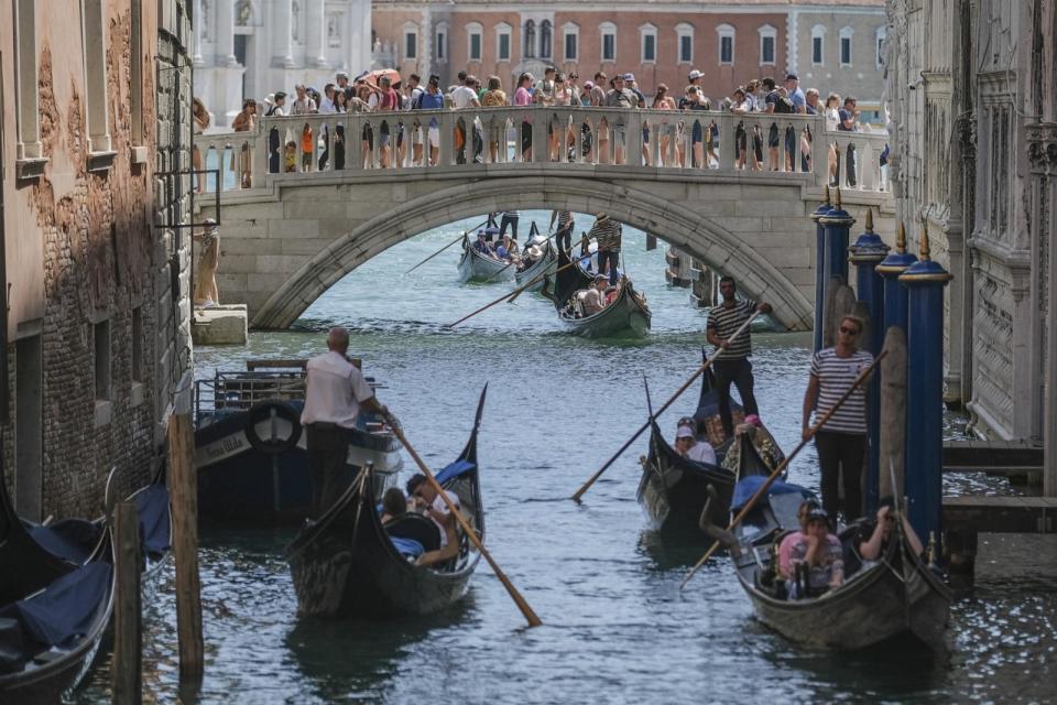 PHOTO: Gondoliers proceed slowly near the Sospiri Bridge near St. Mark's Square due to too much traffic in Venice, Italy, Aug. 02, 2023.  (Stefano Mazzola/Getty Images)