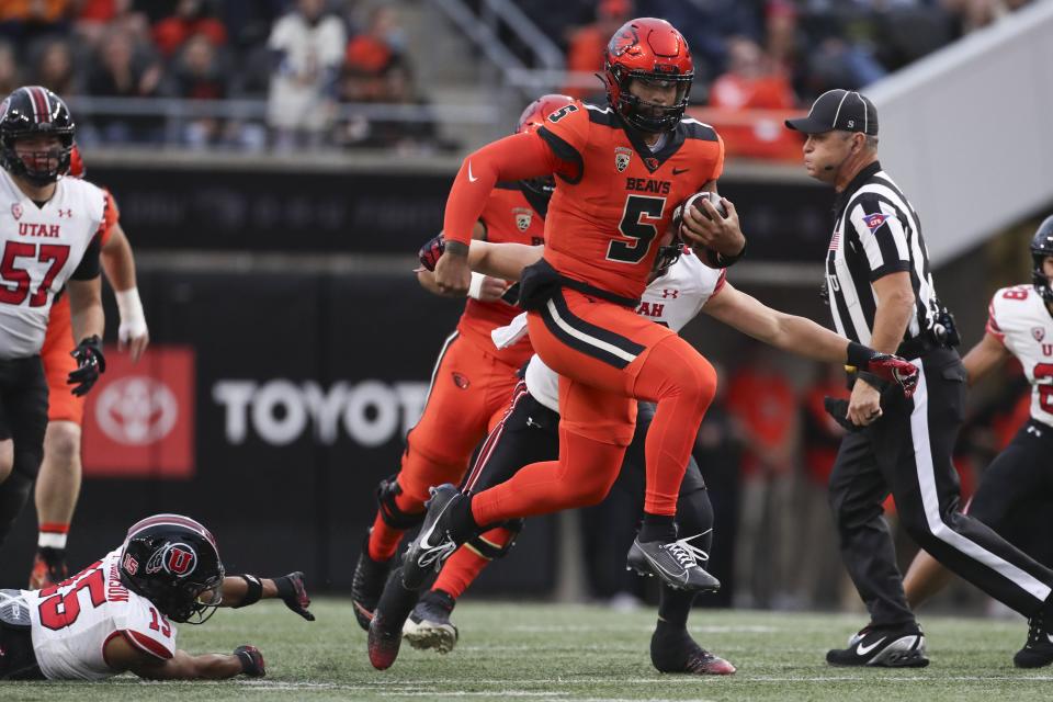 Oregon State quarterback DJ Uiagalelei dodges Utah cornerback Tao Johnson Friday, Sept. 29, 2023, in Corvallis, Ore. | Amanda Loman, Associated Press