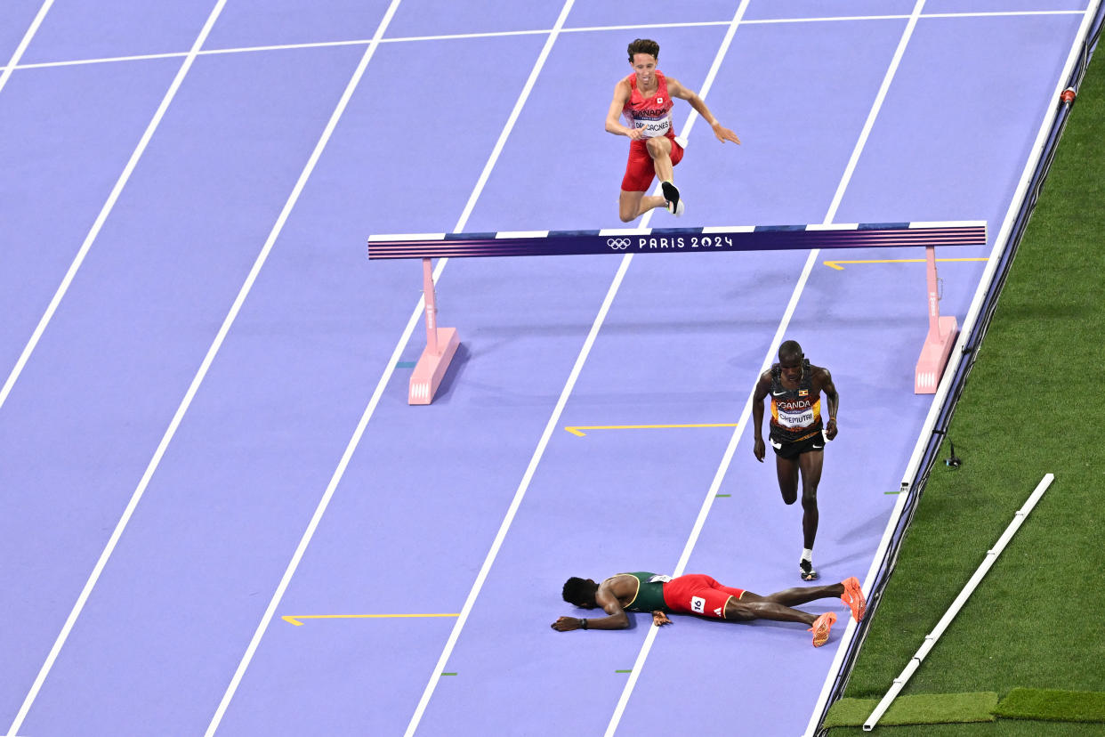 Ethiopia's Lamecha Girma lies on the track during the men's 3000m steeplechase final of the athletics event at the Paris 2024 Olympic Games at Stade de France in Saint-Denis, north of Paris, on August 7, 2024. (Photo by Ben STANSALL / AFP) (Photo by BEN STANSALL/AFP via Getty Images)