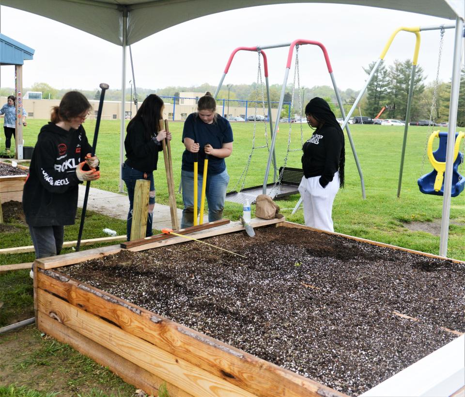 Students dug post holes on Friday to provide handicap accessibility to the raised gardens at Zane Grey Elementary and Intermediate schools. The project was part of the Global Youth Service Day.