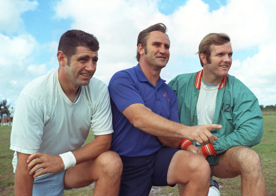 FILE- Miami Dolphins coach Don Shula poses with quarterbacks Earl Morrall, left, and Bob Griese on Jan. 3, 1973, in Miami. The team would go on to to win the Super Bowl over the Washington Redskins later that month. It's quite likely no other Miami team will ever live up to that perfect '72 Dolphins team. That team has almost taken a larger-than-life meaning in the hearts and minds of sports fans. What that team did 50 years ago was difficult enough, but in today's NFL it's a nearly unattainable feat. (AP Photo/Mark Foley, File)
