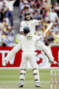 FILE - Australia's Andrew Symonds, back, jumps into the arms of his batting partner Matthew Hayden after Symonds made 100 runs against England at the Melbourne Cricket Ground in Melbourne, Australia on Dec. 27, 2006. Symonds has died, Saturday, May 14, 2022, after a single-vehicle auto accident near Townsville in northeast Australia. He was 46. (AP Photo/Rick Rycroft, File)