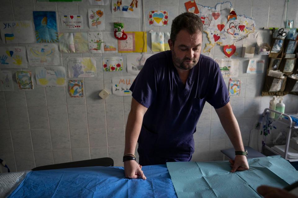 Senior surgical medic Oleksey takes a moment in his makeshift operating theatre