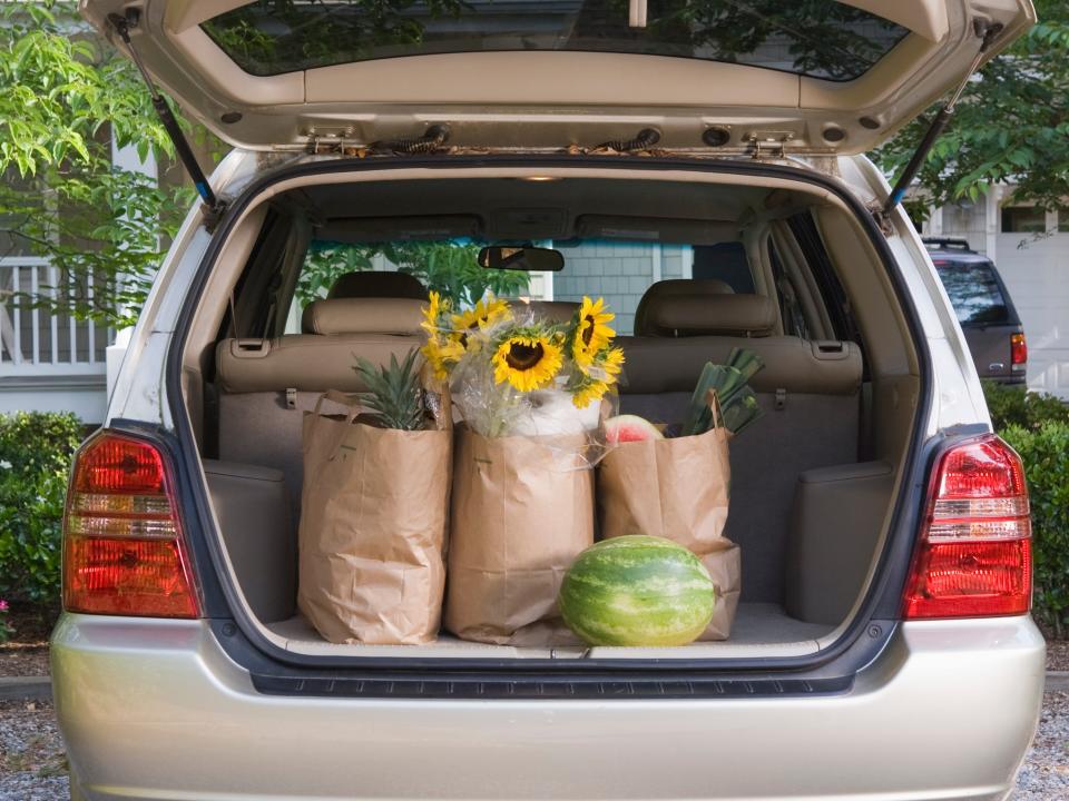 A van with groceries in the trunk.