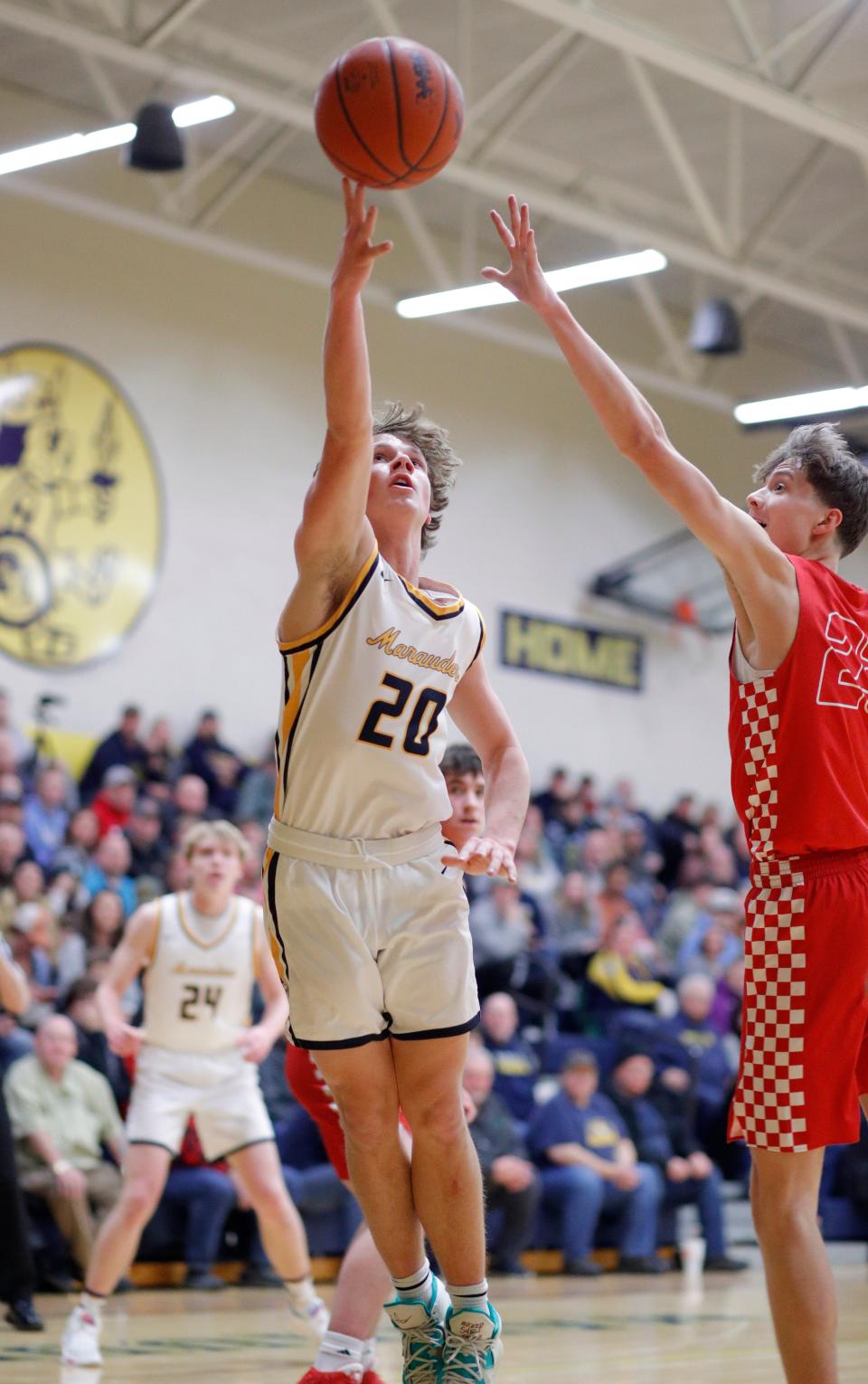 Ovid-Elsie's Tryce Tokar, left, shoots against Laingsburg's Zander Woodruff, Tuesday, Jan. 31, 2023, at Ovid-Elsie High School.