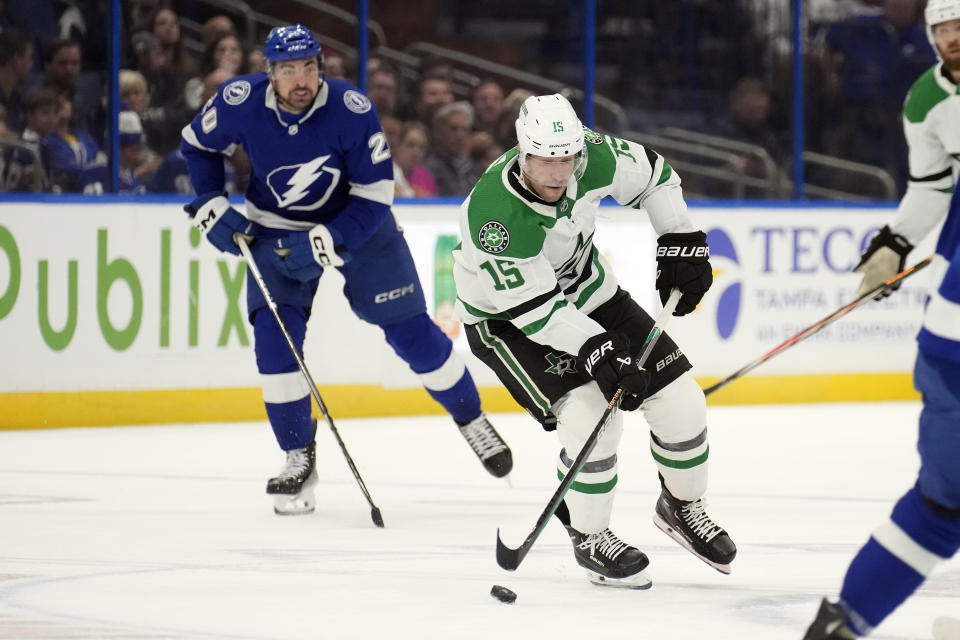 Dallas Stars center Craig Smith (15) cuts around Tampa Bay Lightning left wing Nicholas Paul (20) during the first period of an NHL hockey game Monday, Dec. 4, 2023, in Tampa, Fla. (AP Photo/Chris O'Meara)