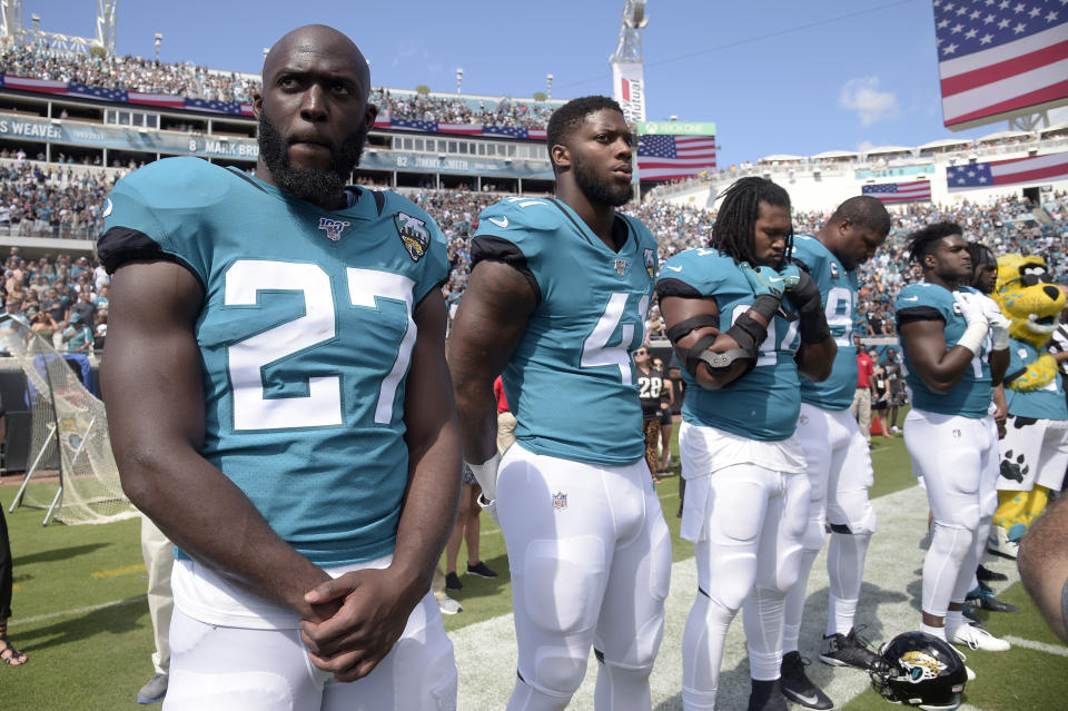 FILE - Jacksonville Jaguars running back Leonard Fournette (27) and defensive end Josh Allen (41) stand on the sideline for the playing of the national anthem before an NFL football game against the New Orleans Saints Sunday, Oct. 13, 2019, in Jacksonville, Fla. The Jacksonville Jaguars have waived running back Leonard Fournette, a stunning decision that gets the team closer to purging Tom Coughlin's tenure.(AP Photo/Phelan M. Ebenhack, File)