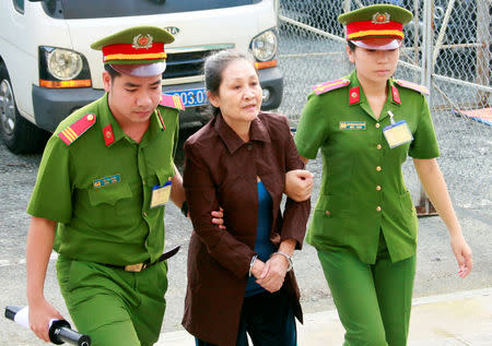 U.S. citizen Angel Phan (C) is escorted by police to a court before her trial in Ho Chi Minh city, Vietnam August 21, 2018. REUTERS/Stringer