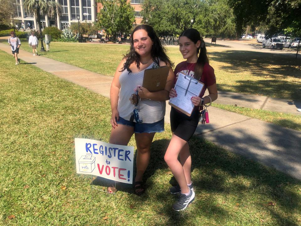 Florida State University students Adrianna Hernandez-Fernandez (left) and Kemely Napoles (right) help students register to vote on Landis Green Monday, October 10, 2022.