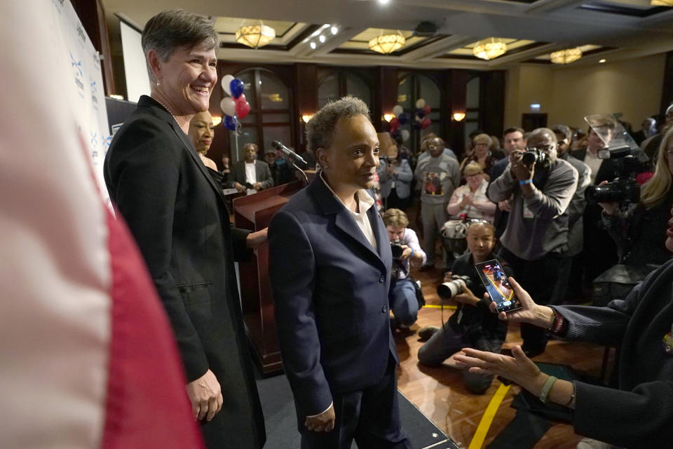 Chicago Mayor Lori Lightfoot, right, walks off the stage with her spouse Amy Eshleman after conceding the mayoral election Tuesday, Feb. 28, 2023, in Chicago. (AP Photo/Charles Rex Arbogast)