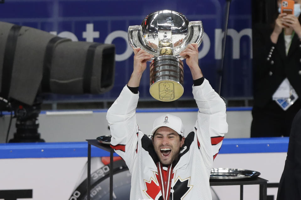 Canada's Adam Henrique holds the trophy after winning the Ice Hockey World Championship final match between Finland and Canada at the Arena in Riga, Latvia, Sunday, June 6, 2021. (AP Photo/Sergei Grits)