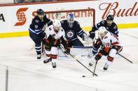 Feb 16, 2019; Winnipeg, Manitoba, CAN; Ottawa Senators forward Ryan Dzingel (18) and forward Chris Tierney (71) look for a rebound in front of Winnipeg Jets goalie Laurent Brossoit (30) during the overtime period at Bell MTS Place. Mandatory Credit: Terrence Lee-USA TODAY Sports