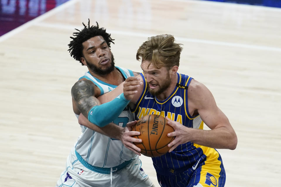 Indiana Pacers' Domantas Sabonis,right, goes to the basket against Charlotte Hornets' Miles Bridges (0) during the first half of an NBA basketball Eastern Conference play-in game Tuesday, May 18, 2021, in Indianapolis. (AP Photo/Darron Cummings)