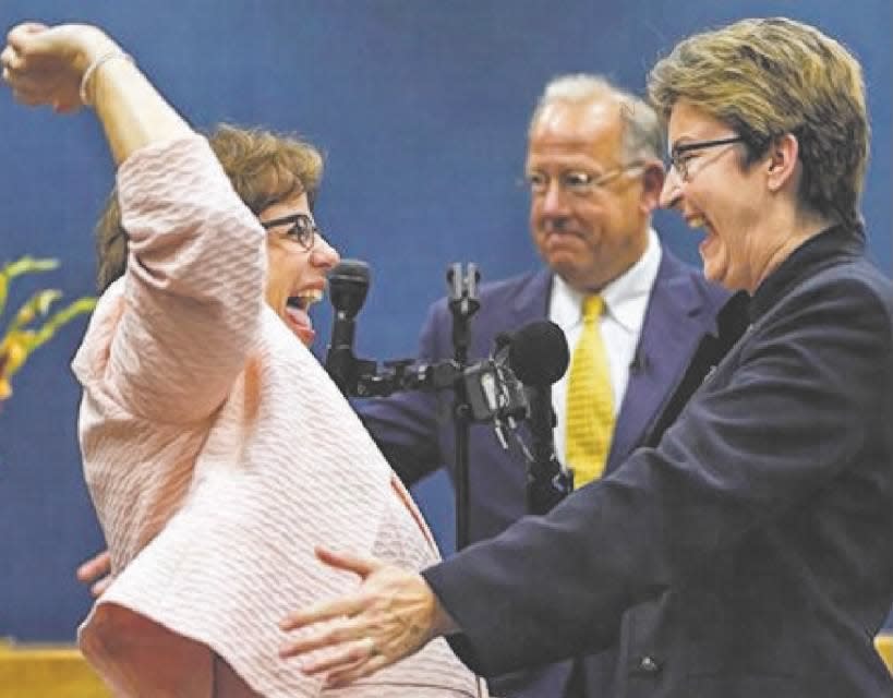 Beth Asaro (left) and Joanne Schailey celebrate after exchanging vows as Lambertville Mayor David DelVecchio officiates on Monday, Oct. 21, 2013.