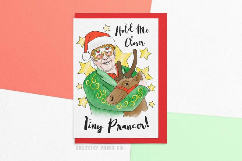 <p><a href="https://go.redirectingat.com?id=74968X1596630&url=https%3A%2F%2Fwww.etsy.com%2Flisting%2F750810485%2Fchristmas-card-hold-me-closer-tiny&sref=https%3A%2F%2Fwww.thepioneerwoman.com%2Fholidays-celebrations%2Fg38114326%2Ffunny-christmas-card-ideas%2F" rel="nofollow noopener" target="_blank" data-ylk="slk:Shop Now;elm:context_link;itc:0;sec:content-canvas" class="link rapid-noclick-resp">Shop Now</a></p><p>Hold Me Closer Tiny Prancer Christmas Card</p><p>etsy.com</p><p>$3.82</p><span class="copyright">Etsy</span>