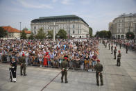 People attend the ceremony marking the Polish Army Day in Warsaw, Poland, Monday, Aug. 15, 2022. The Polish president and other officials marked their nation's Armed Forces Day holiday Monday alongside the U.S. army commander in Europe and regular American troops, a symbolic underlining of NATO support for members on the eastern front as Russia wages war nearby in Ukraine. (AP Photo/Michal Dyjuk)