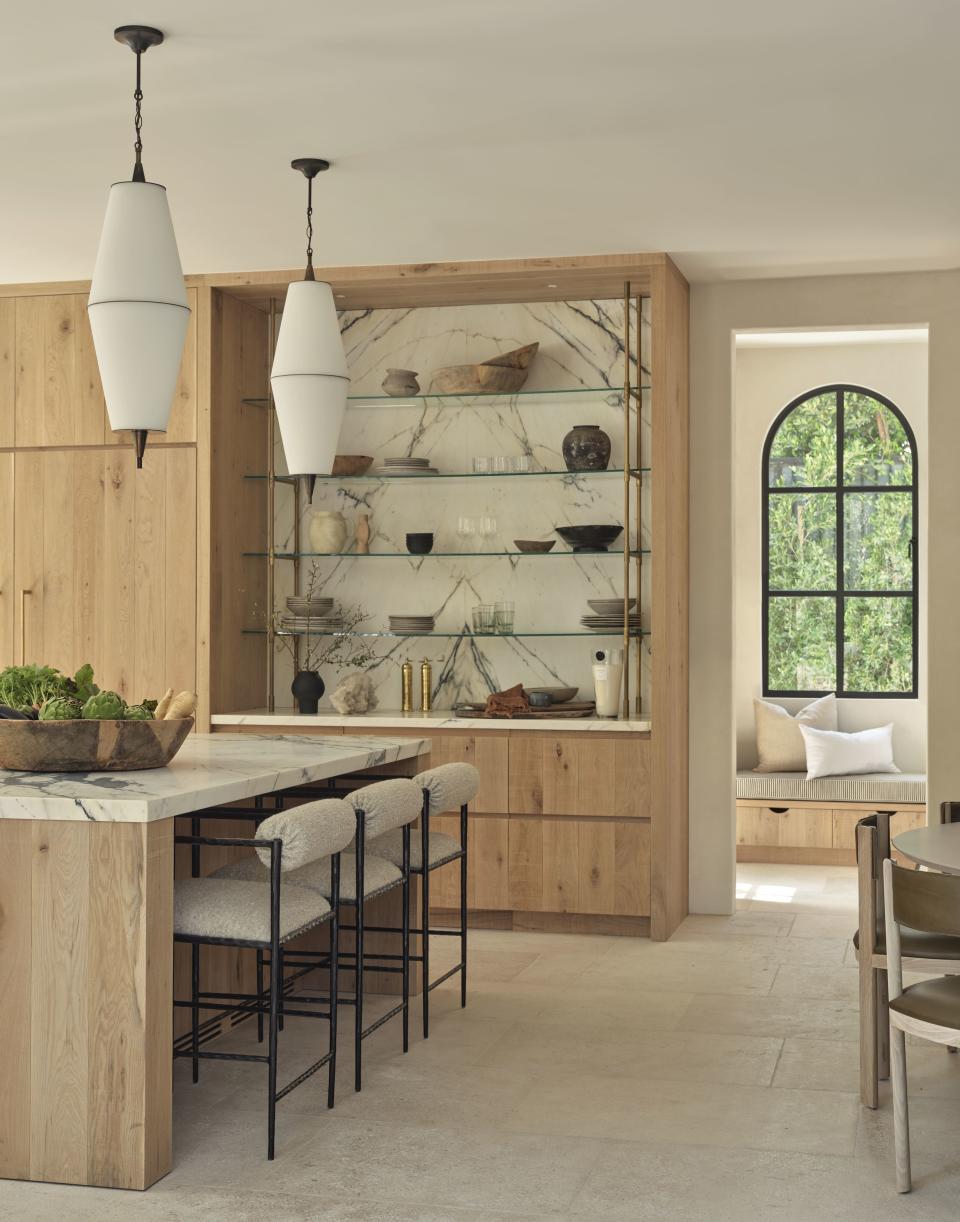 A kitchen with a storage shelf