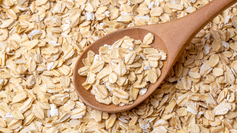 rolled oats on wooden spoon