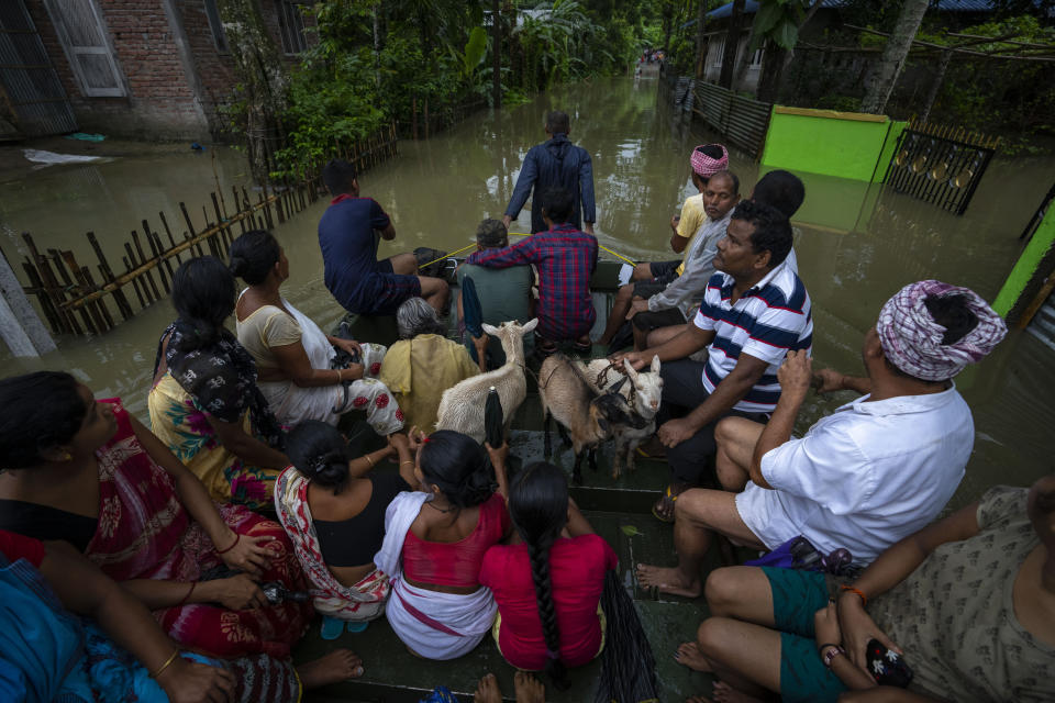 Indian army personnel rescue flood-affected villagers on a boat in Jalimura village, west of Gauhati, India, Saturday, June 18, 2022. (AP Photo/Anupam Nath)
