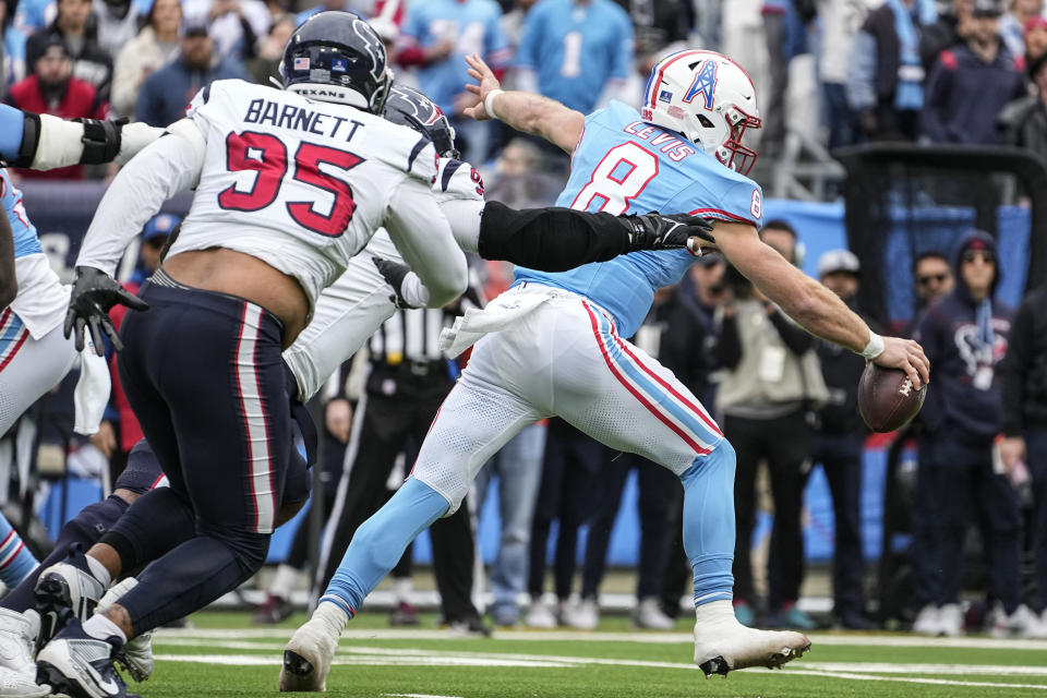 Tennessee Titans quarterback Will Levis (8) runs out of the pocket against Houston Texans defensive end Derek Barnett (95) during the first half of an NFL football game, Sunday, Dec. 17, 2023, in Nashville, Tenn. (AP Photo/George Walker IV)