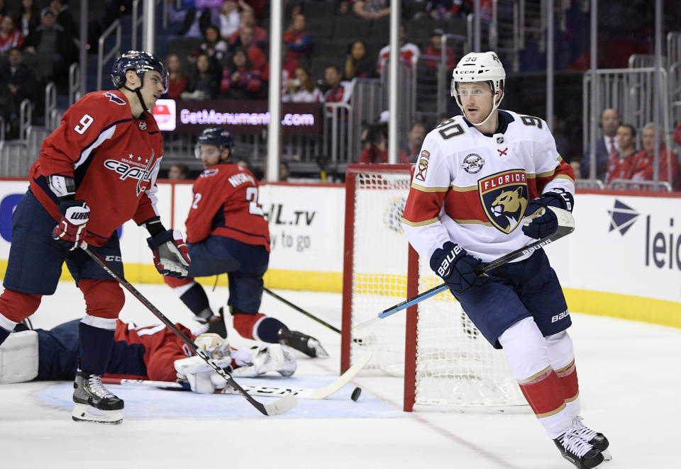 Florida Panthers center Jared McCann (90) celebrates his goal as Washington Capitals defenseman Dmitry Orlov (9), of Russia, goaltender Braden Holtby, bottom, and defenseman Matt Niskanen (2) react during the first period of an NHL hockey game, Friday, Oct. 19, 2018, in Washington. (AP Photo/Nick Wass)