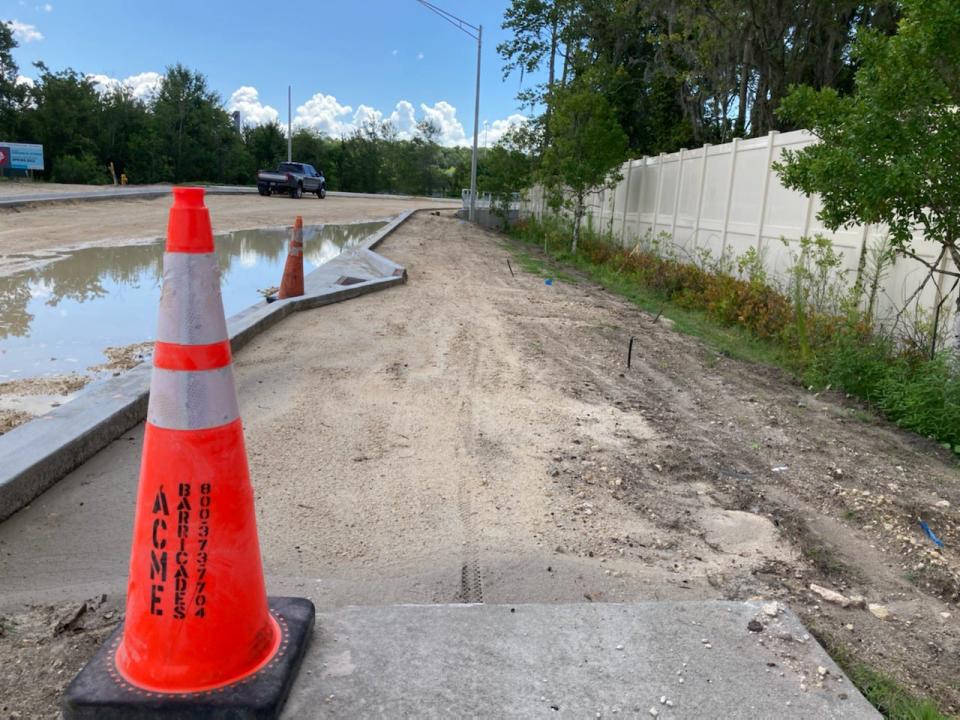 Bicycle tracks and footprints continue where the concrete stops on a multi-use path being built on an extension of Parramore Road being built between Collins Road and Youngerman Circle on Jacksonville's Westside.