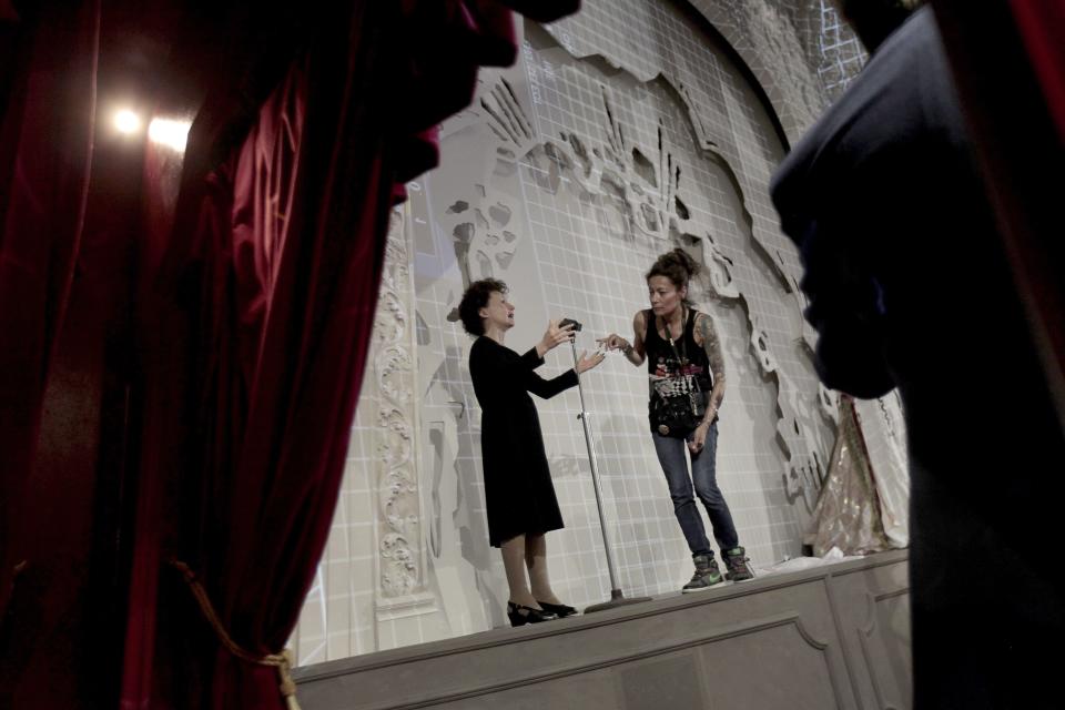 Paris' Grevin Wax Museum hairdresser Virginie Dahan checks French singer Edith Piaf statue at the Grevin Wax Museum in Prague